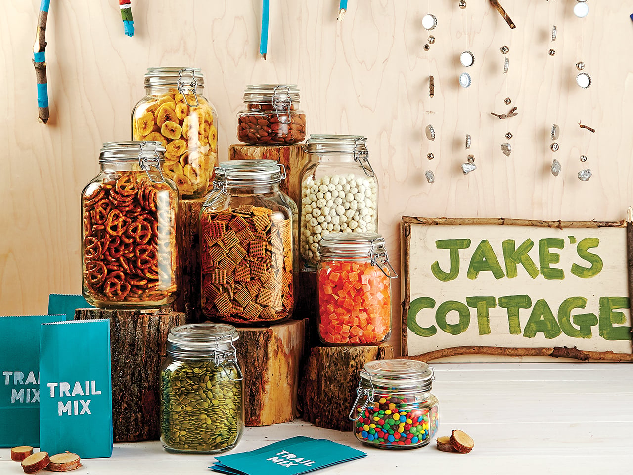 Jars full of treats for a make your own trail mix bar for a Cottage themed party