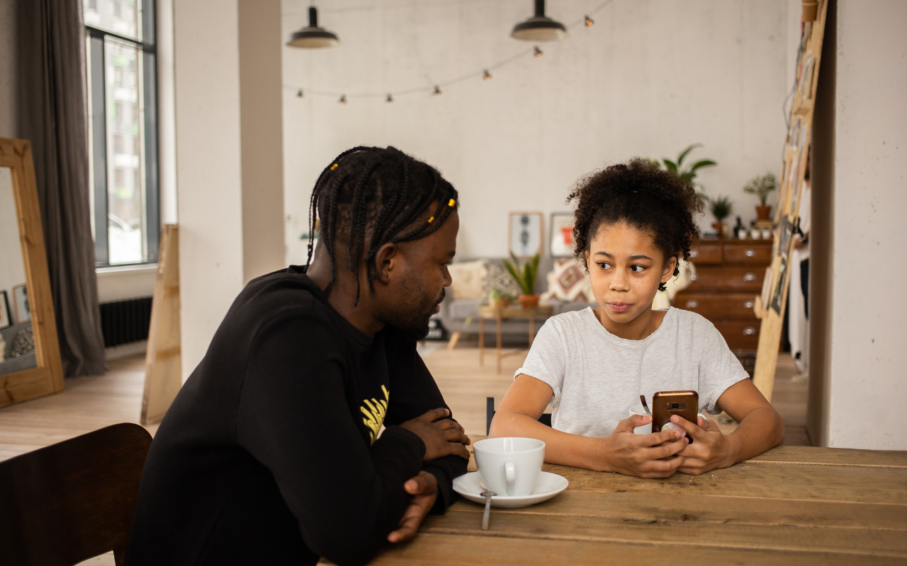 dad talking to child at the kitchen table