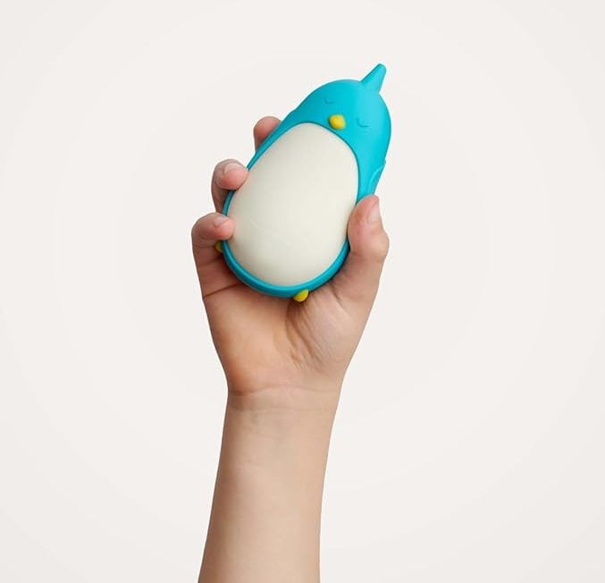 A child’s hand holding a Moonbuddy.