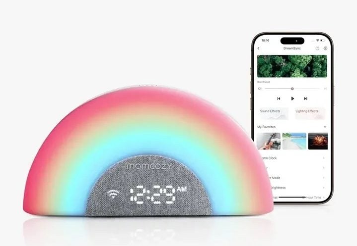 Rainbow-shaped sound machine and alarm clock with glowing LED light and smartphone app controls displayed beside it.